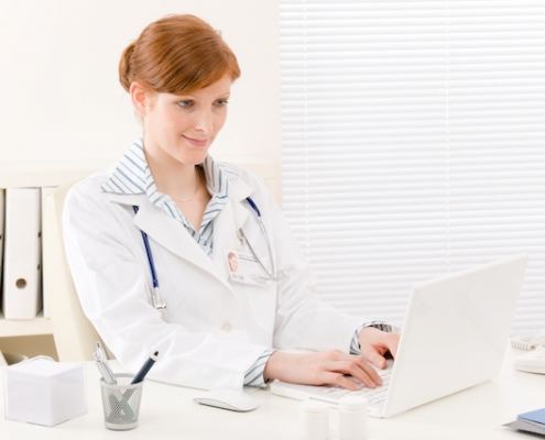 Doctor office - female physician work in front of computer
