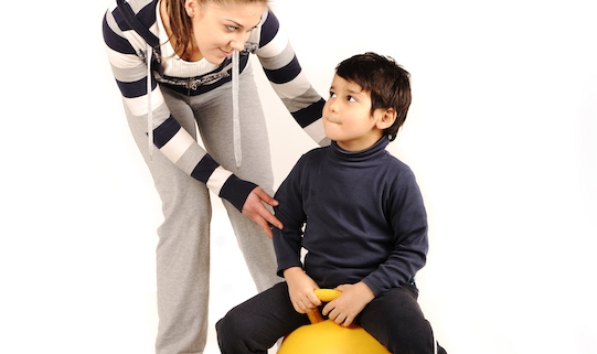 Family - young woman and kid - doing sport, fitness exercises